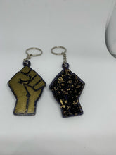 Load image into Gallery viewer, fist bronze with transparent black with gold flakes
